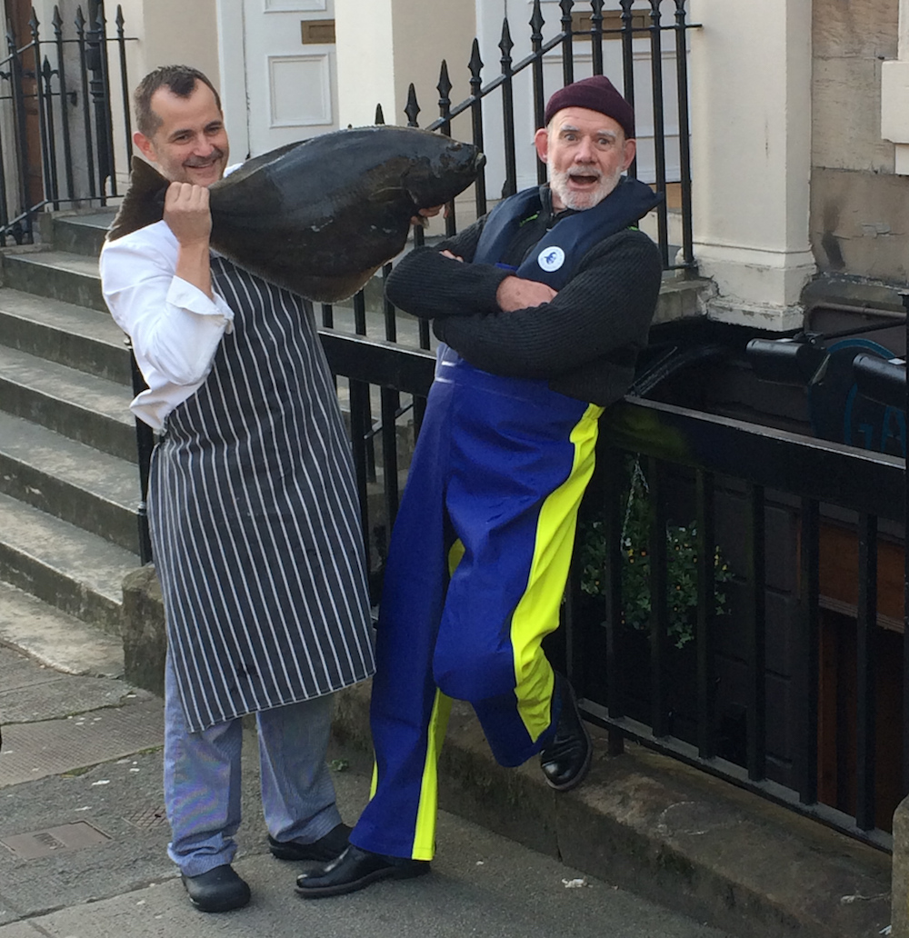 Chef Derek and Tomfrom the Fishermen's Mission get to grips with the fish of the day.