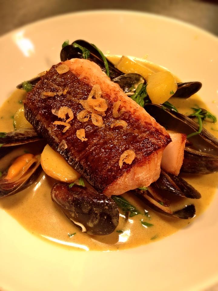 The Riverhill restaurants serve global dishes such as this smoked cod in a curried coconut broth with mussels.