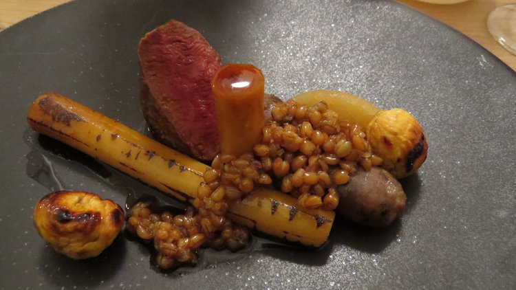 Venison loin and sausage, salsify, wheatgrain and roast chestnuts.