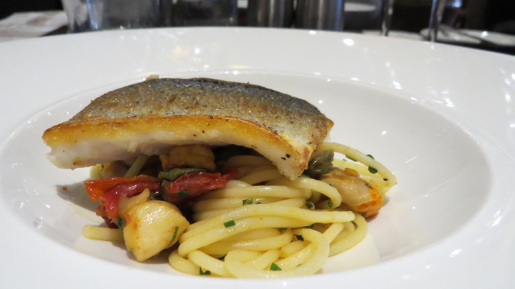 Fillet of sea bass with seafood linguine, crayfish, queenie scallops, capers, sun-dried tomatoes and soft herbs. 