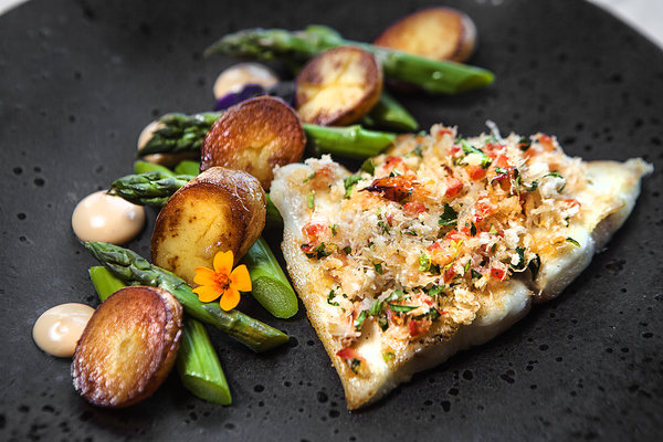 Halibut with crab, Parmesan & tomato crust, char grilled asparagus, sauteed potatoes and lobster emulsion.