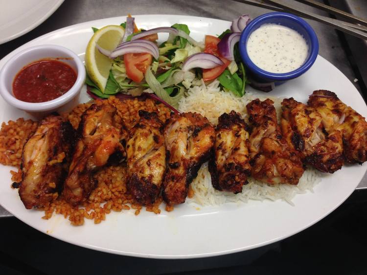 The chicken wings are marinated, cooked on the charcoal BBQ and served with basmati rice, bulgur, salad and a garlic and chilli sauce.